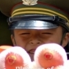 Child soldier behind an apples heap