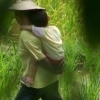 Chengshan : woman and baby in rice field