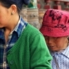 Mother and daughter turning the prayers mills